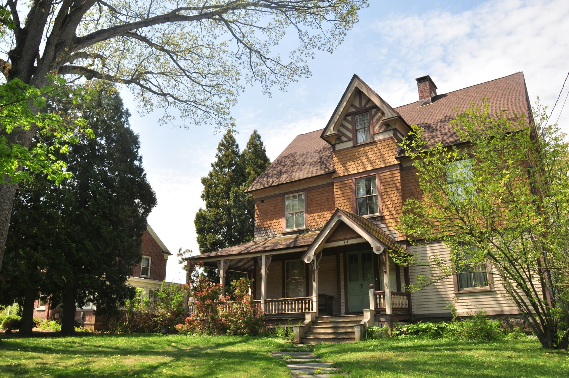 Professional pest control technician treating a beautiful home in winter